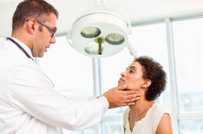 Doctor tests woman thyroid function